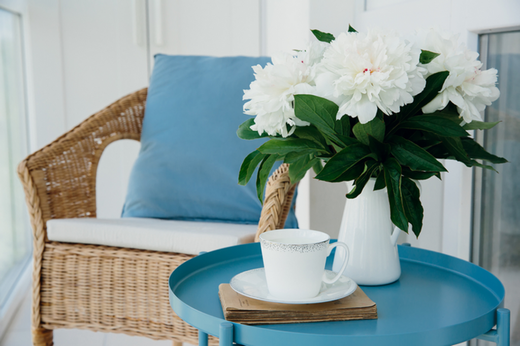 Try to mix and match different furniture styles for your condo balcony lounge.